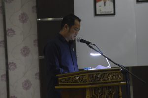 Anggota Fraksi Demokrat, Leonardo Agustono Silalahi, terpaksa menggunakan penerangan tambahan ketika membacakan Pedapat Akhir (PA) Fraksi, sebelum ketuk palu APBD Sanggau 2019, Jumat (30/11) malam di gedung DPRD Sanggau. FOTO/Ram